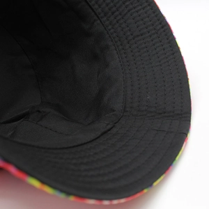 Detailed close-up of interior black twill fabric and rainbow checkered brim stitching