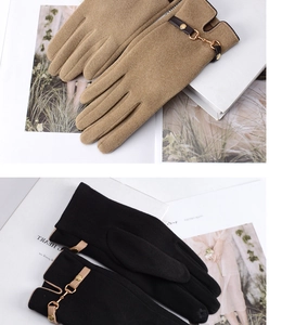 Close-up of winter thermal gloves with stylish metal chain buckle in black and camel colors