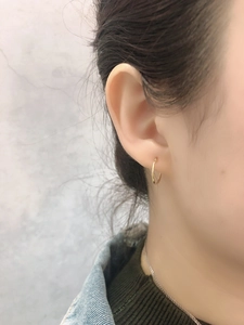 Minimalist gold hoop earring on model showing modern style and elegant profile