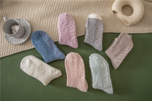 Detail view of colorful non-slip fuzzy slipper socks with silicone grippers on warm fleece