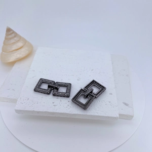 Detail of square interlocking jewelry clasps with gunmetal finish and micro-set cubic zirconia