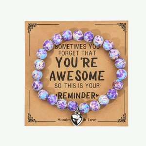 Macro shot of 8mm zebra Jasper heart bracelet with inspirational gift card for women