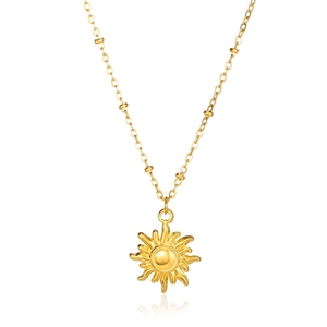 Detailed view of a golden sun pendant necklace with radiated rays and beaded chain