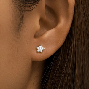 Detailed close-up of a silver marquise crown ear stud with sparkling gems on a model
