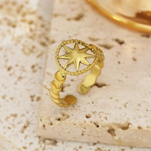 Detailed macro of a 18k gold plated stainless steel ring with hollow star design