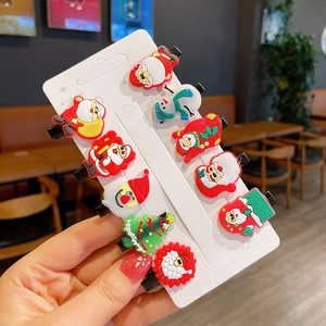 Detail view of 10-piece Christmas hair clip set featuring Santa and tree designs