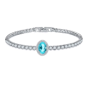 Detailed macro view of the oval aquamarine stone with halo and tennis chain stones