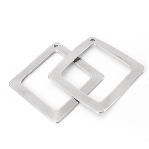 Macro detail of two square silver stainless steel pendants on a white background