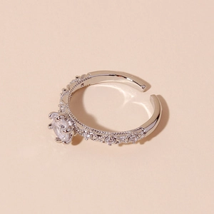 Minimalist silver open ring with large clear central gemstone and textured band