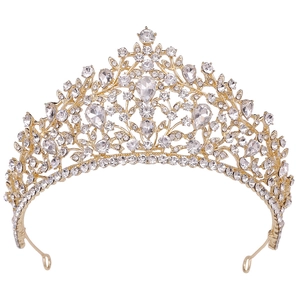 Close-up of golden bridal crown with intricate hollow vine patterns and teardrop rhinestones