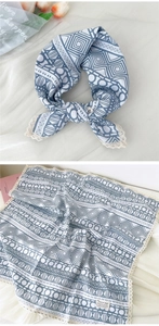 Detail view of blue and white geometric square scarf with delicate lace edging