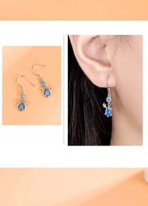 Detail of S999 sterling silver deer antler earrings with blue teardrop gemstones