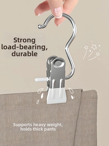 Detail of stainless steel clothes peg with white protective pads holding thick fabric