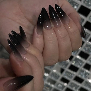 Short almond press-on nails featuring a black French gradient design and glossy finish