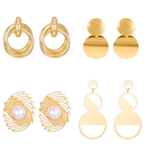 Set of four gold geometric earrings with layered rings, solid discs and pearl details