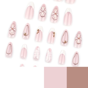 Pink almond press-on nails featuring 3D embossed flowers, pearls, and French tips
