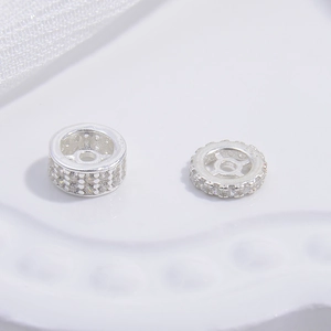 Macro shot of S925 sterling silver spacer beads with double-row cubic zirconia inlay