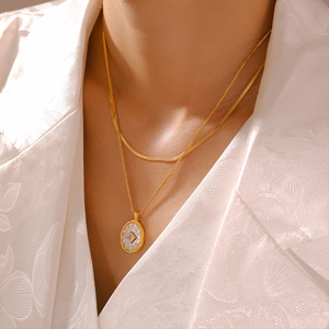 Double-layered 18k gold plated necklace with oval mother of pearl pendant and snake chain