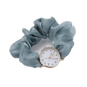 Women's gold watch with grey-blue satin scrunchie strap and floral sunflower dial