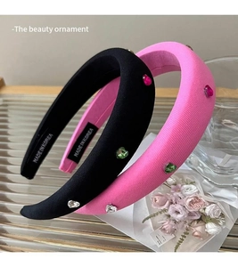Detail of pink and black padded headbands with colorful heart rhinestones on glass