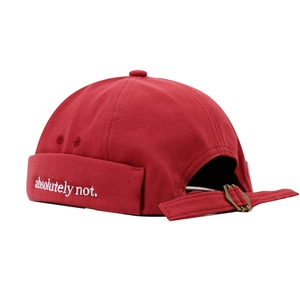 Red canvas brimless docker cap with white 'absolutely not' embroidery and metal buckle