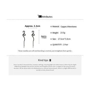 Detailed view of long black snake-shaped tassel earrings with rhinestones and copper material