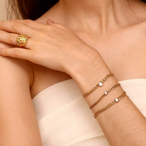 Detail of 18K gold plated chain bracelets with marquise and round zircon on model's wrist