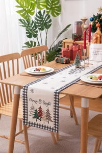 Detailed view of Merry Christmas table runner with festive trees and plaid edges