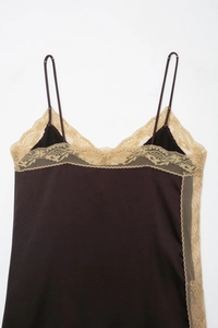 Close-up of coffee brown satin top featuring delicate beige floral lace trim detail