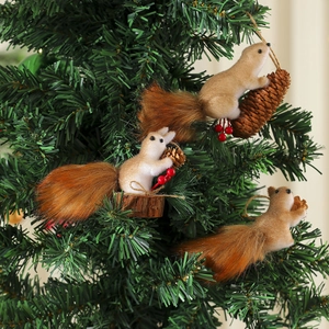 Three decorative foam squirrel ornaments with pine cones on a green Christmas tree branch