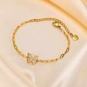 Detail view of 18K gold plated bracelet with zircon butterfly on champagne silk