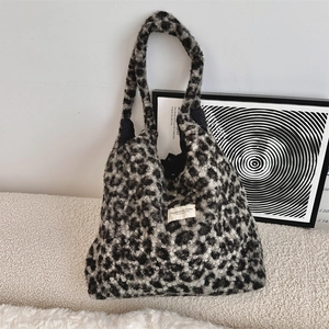 Detail of soft leopard print faux fur tote bag with SOZAKKA woven label and plush texture