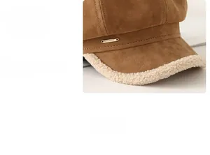 Detail of suede newsboy hat brim with faux shearling trim and gold metal logo accent