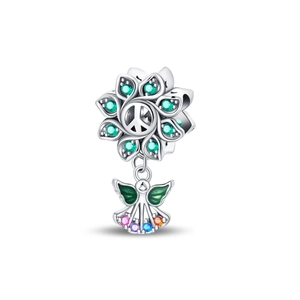 Macro detail of silver plated angel charm with olive branch and colorful gemstones