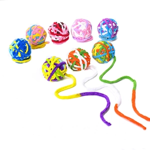 Macro shot of colorful knitted cat toy balls with long tails and soft chenille texture