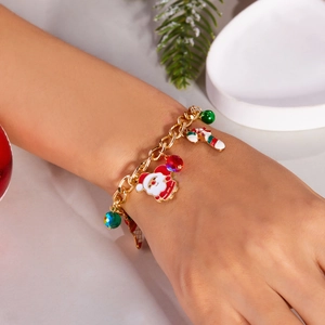 Golden Christmas bracelet with Santa Claus and candy cane charms on a wrist