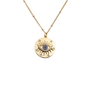 Golden Evil Eye necklace with blue zircon pendant and beaded gold chain on white background