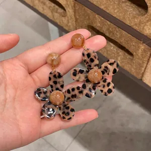 Elegant resin leopard print flower earrings with amber petals and gold metal studs