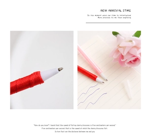 Detailed macro shot of silk-wrapped rose flower ballpoint pen with writing tip