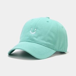 Minimalist mint green cotton baseball cap featuring a white embroidered smiley face design