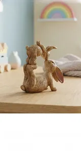 Detail of resin rabbit statues with realistic wood grain texture for home decor