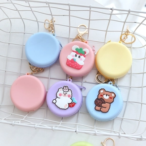 Cute round silicone coin purses in pastel blue, pink, yellow, and purple with cartoon charms