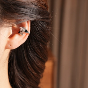 Detail of silver double-layered snake ear cuff with white zircon and black enamel finish