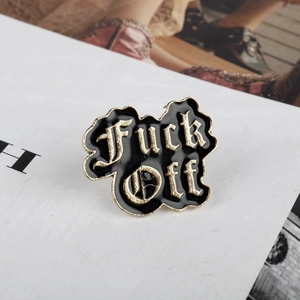 Punk style gothic Fuck Off enamel pin with golden metal edges and black finish