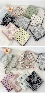 Detail of assorted cotton linen scarves featuring floral and heart patterns for hair
