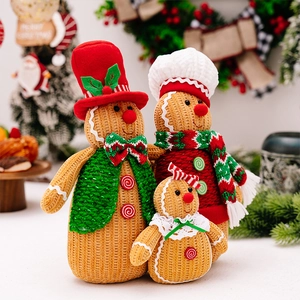 Detail of Christmas gingerbread man family set with red scarves and knitted textures