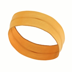Close-up of mustard yellow elastic sports headband showing breathable fabric texture