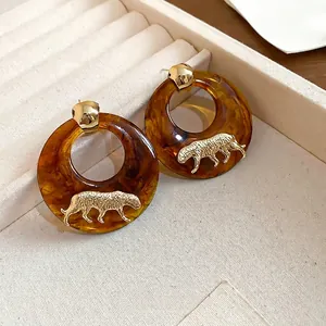 Maillard resin amber leopard earrings with gold accents and geometric hoop design
