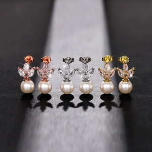 Detailed view of marquise cut zircon and white pearl earrings in three metal finishes