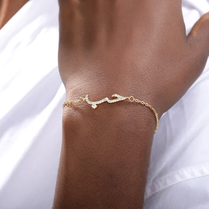 Arabic love declaration charm bracelet with zircon stones on a female model wrist